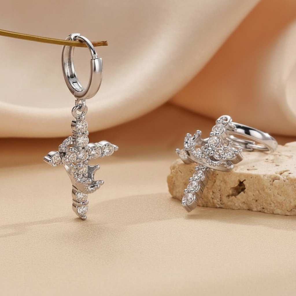 Silver cross and crown earrings styled shot