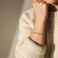 Square cream sweater with natural hand and bracelet